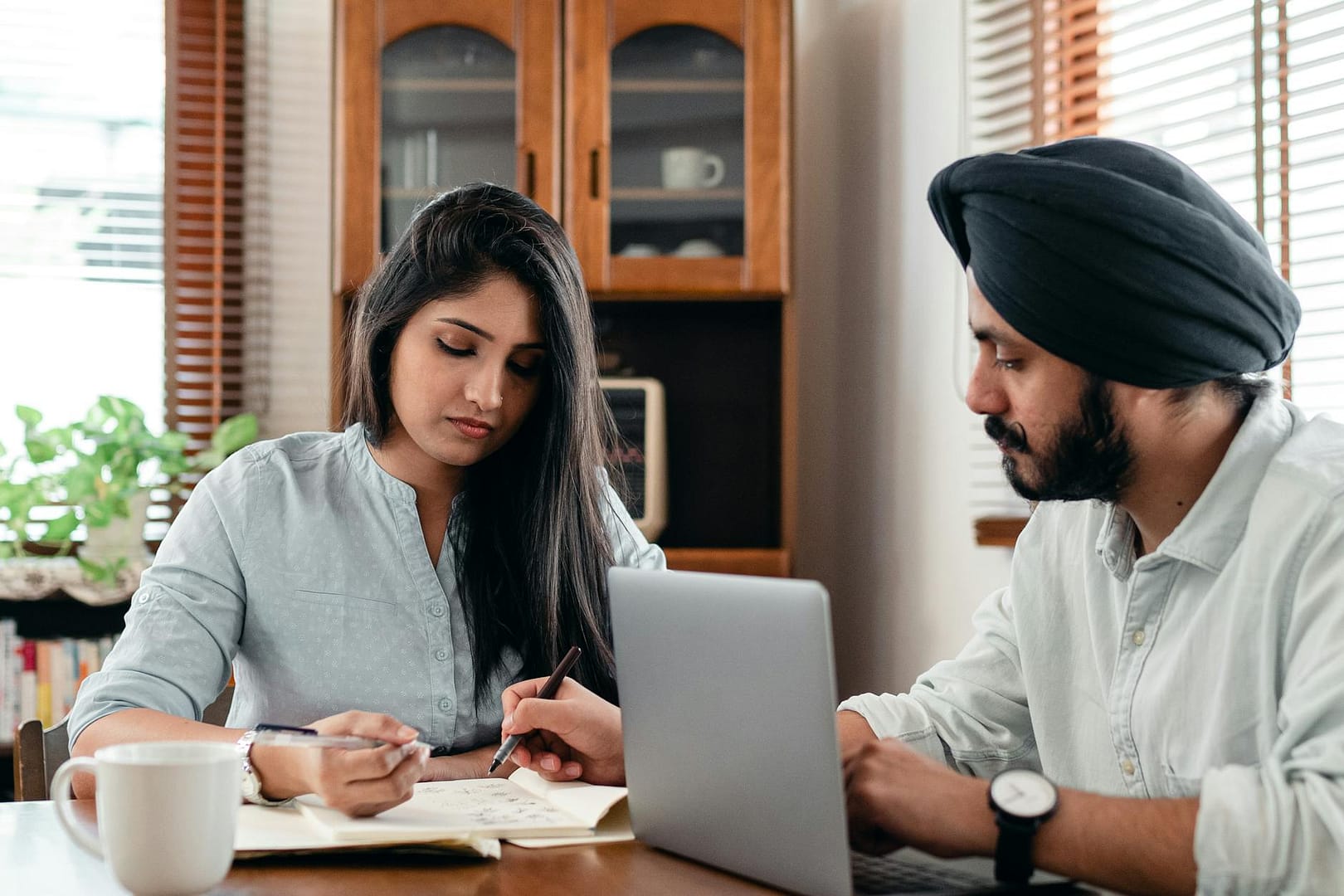 concentrated coworking couple discussing project together